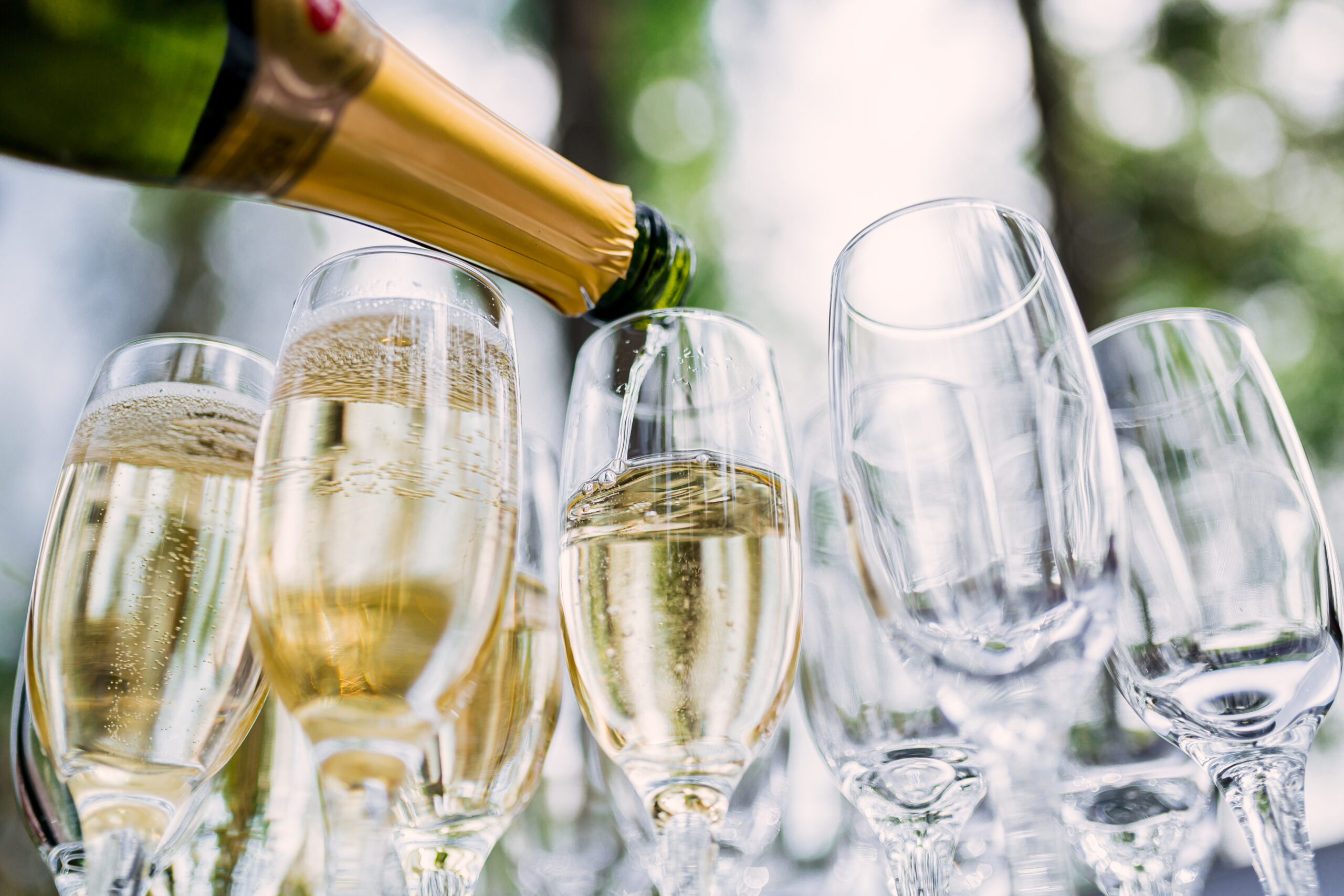 the waiter pours champagne in glasses on the street wedding ca